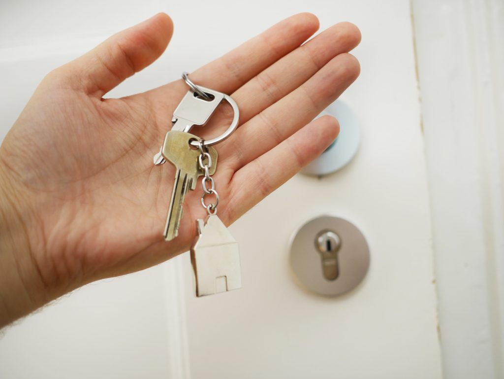 a person holding a key in front of a door